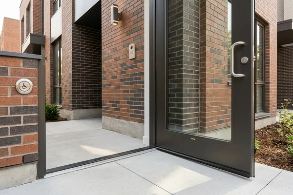 Accessible ground-floor sixplex unit entrance with level threshold