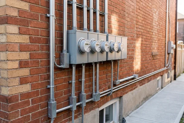 Bank of separate hydro meters on a converted Toronto house