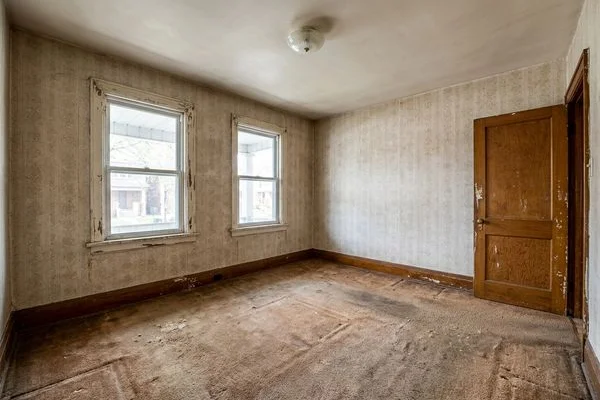 Before: dated living room with worn carpet