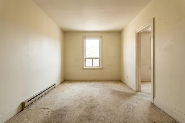 Dated main-floor living room before conversion