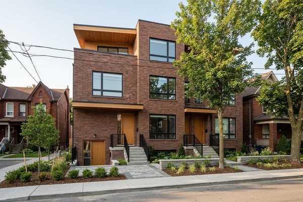 Finished brick fourplex with four entrances on a Toronto street