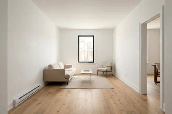 Same living room after conversion with oak floor and white walls