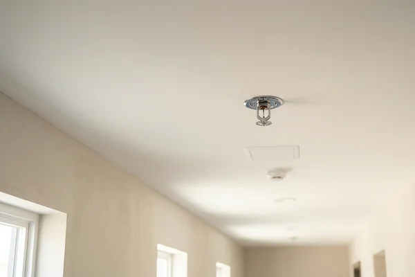 Sprinkler heads in the sixplex corridor