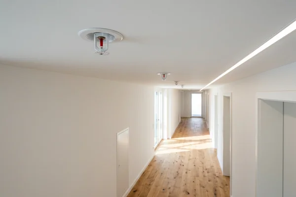 Sprinkler heads in a finished multiplex corridor ceiling