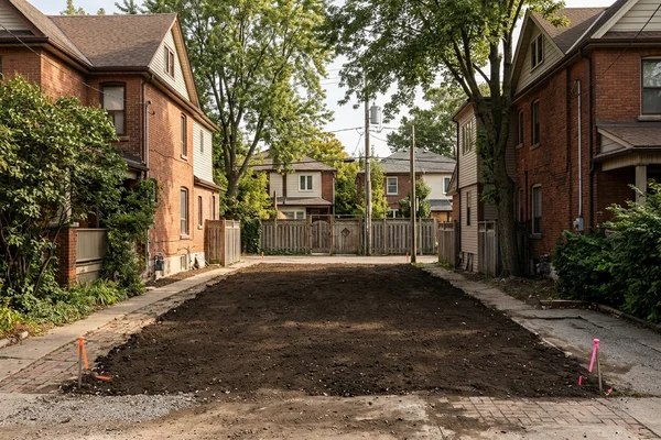 Surveyed infill lot with property pins and a lane behind